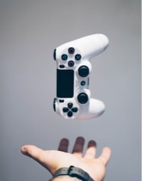 Video game controller hovering above a person's hand